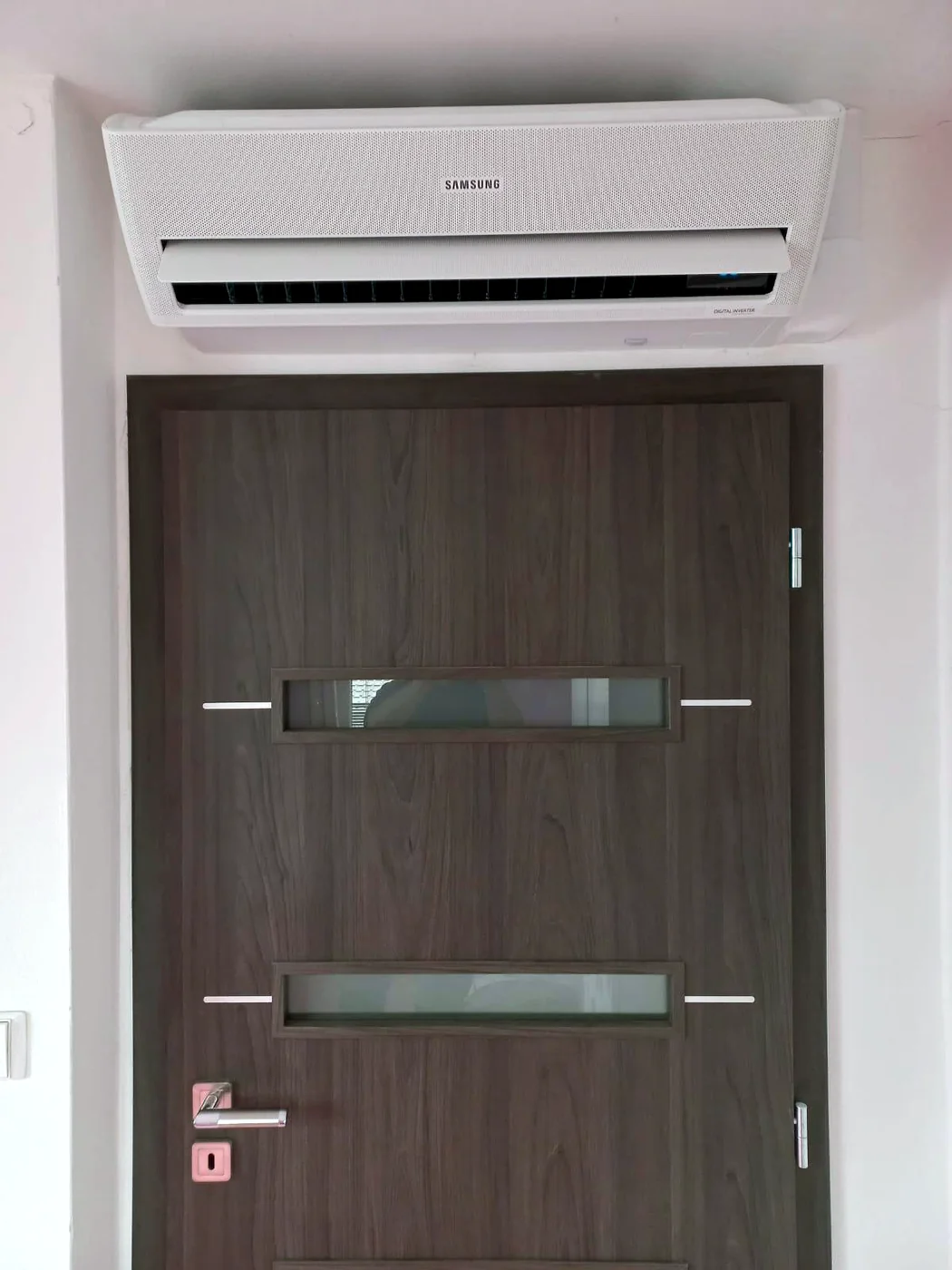 Nástěnná klimatizace Samsung WindFree nad dveřmi pokoje